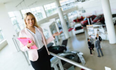 Elegant salesperson working at car dealership